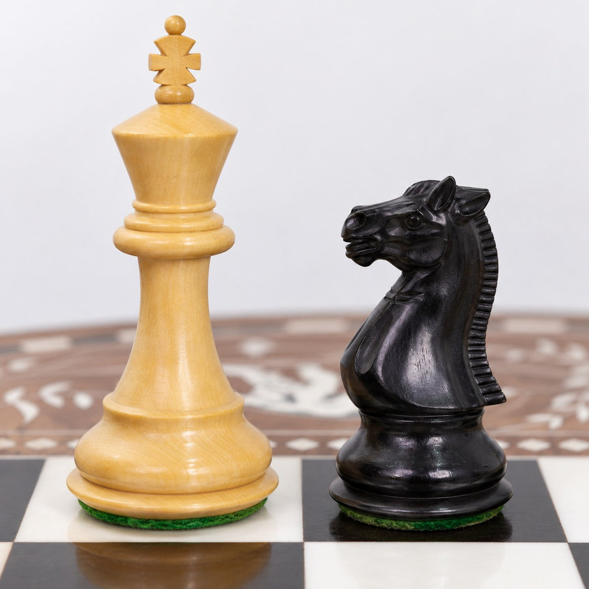 24" Luxury Boutique Round Chess Table with Weighted Ebonized Boxwood Staunton Chess Pieces - king and knight close-up